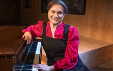 Anita Hollander sitting at a piano