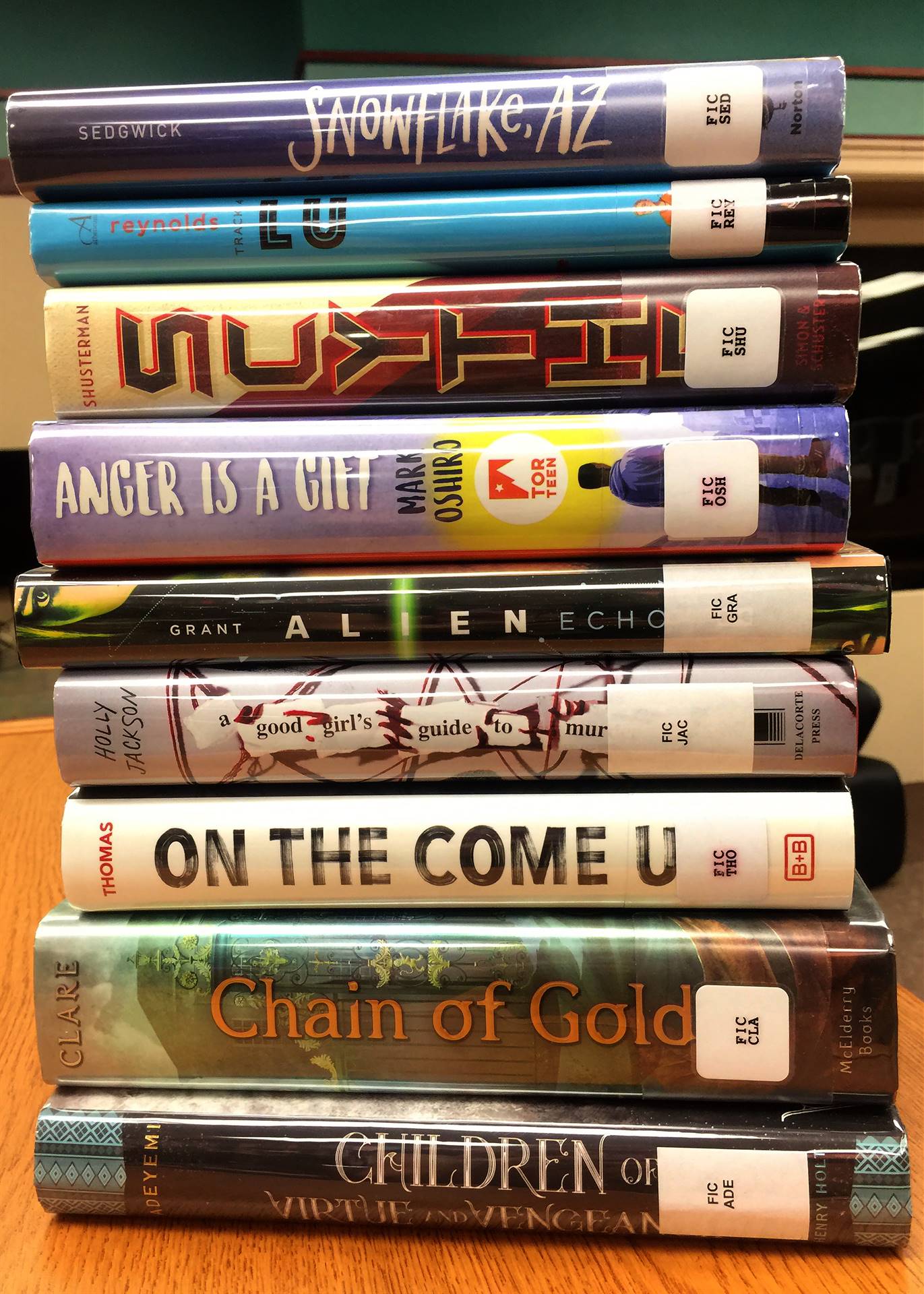 Stack of nine books, spines facing out